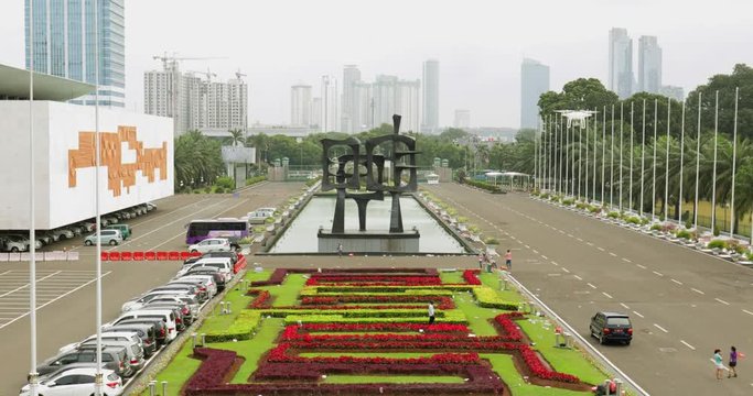 JAKARTA - Indonesia. March 29, 2018: Beautiful landscape of Indonesian Parliament building park with skyscrapers background. Shot in 4k resolution