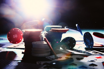 Poker chiips falling with back flash lighting.