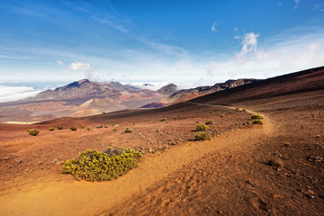 Wide volcanic landscape with lava fields in different colors, wide view, ocher shades, reds, trail,...