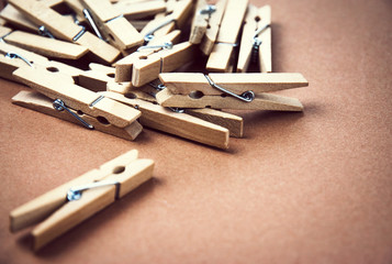 wooden pegs for clothes on brown paper
