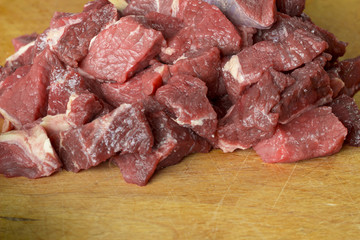 Raw meat is sliced for cooking.