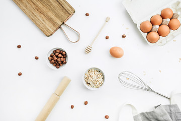 Muesli ingredients on white background. Flat lay, top view. Healthy nutrition concet.