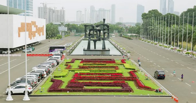 JAKARTA - Indonesia. March 29, 2018: Beautiful view of park at the Indonesian Parliament building with skyscrapers background. Shot in 4k resolution