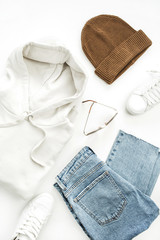 Woman casual fashion clothes and accessory set on white background. Flat lay, top view.