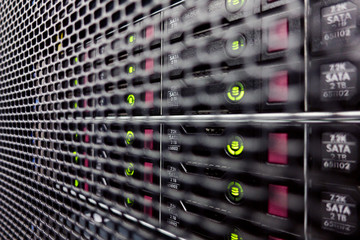 Server hard drives SATA. Internet server in datacenter close-up view. Hard drives in a computer rack