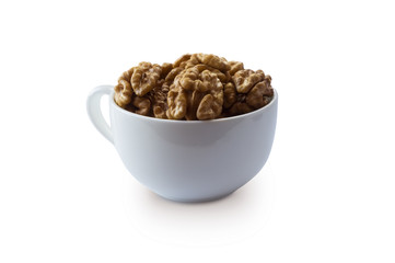 Kernels walnuts isolated on white. Walnuts in a cup isolated on white background. Walnuts with copy space for text on a white background