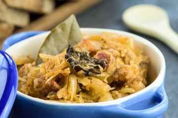 Bigos - traditional Polish Easter and Christmas dish - closeup in blue bowl.