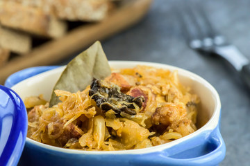 Bigos - traditional Polish Easter and Christmas dish - closeup in blue bowl.