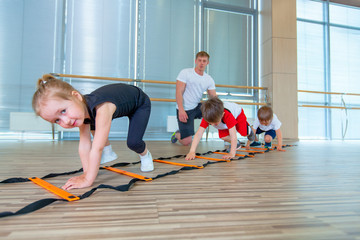 Happy sporty children in gym. Kids exercises
