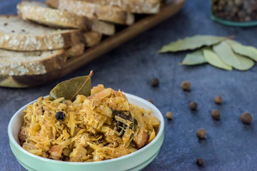 Bigos - traditional Polish Easter and Christmas dish - closeup in green bowl.