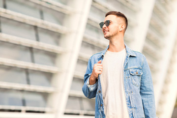 Fototapeta premium fashion guy posing in sunglasses on sunset