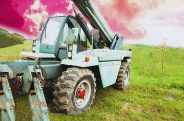Wheel loader machine unloading rocks in the open-mine of iron ore
