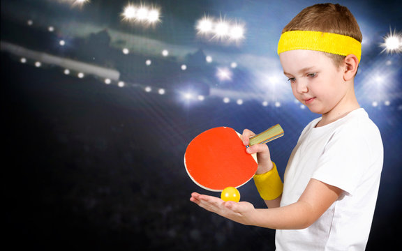 Portrait of a child boy playing ping-pong.	