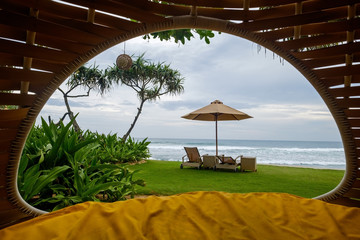 Cozy place inside cocoon hammock. View on tropical indian ocean. Concept of rest and vacation in asia with pleasure