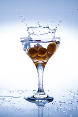 Splash in a glass with yellow berries