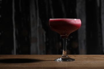 Raspberry cocktail on wooden table. Close up