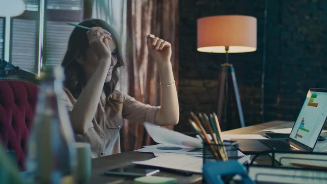 Happy business woman reading good news on laptop computer in office. Successful businesswoman satisfied with business statistics analysis. Smiling woman enjoy financial data report on notebook