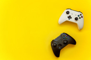 Black and white joystick on yellow background. Computer gaming competition videogame control confrontation concept © Юлия Завалишина