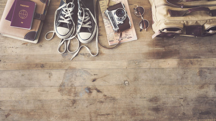 Travel concept with passport camera map bag on wooden background