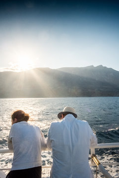 Couple admiring seascape and mountain from boat, Crete, Greece
