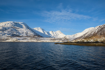 Fototapeta na wymiar Bright landscapes taken from the waters of the Fjords around Tromsø, Norway