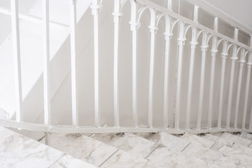 Beautiful Marble staircase with white railing leading down