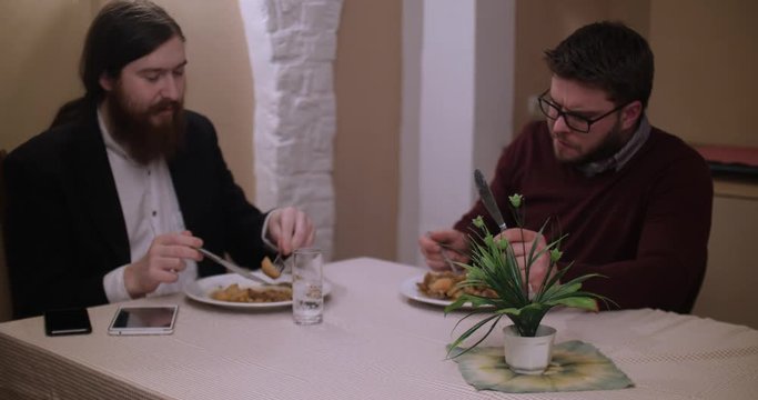 Two men having lunch in a restaurant