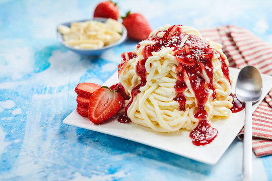 Spaghetti ice cream with strawberry sauce