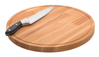 round wooden cutting board and metal knife on a white background