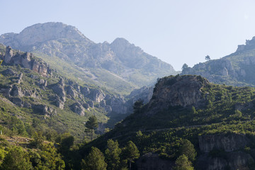 Fototapeta na wymiar landscape image at Puertos de Beceite national park showing the beautiful rocky hills with dense vegetation and nice morning sunlight