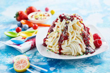 Spaghetti ice cream dessert with raspberry sauce