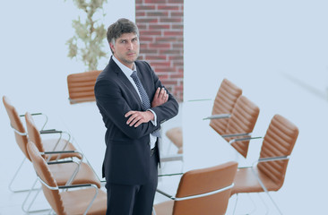 Business man standing in an empty meeting room