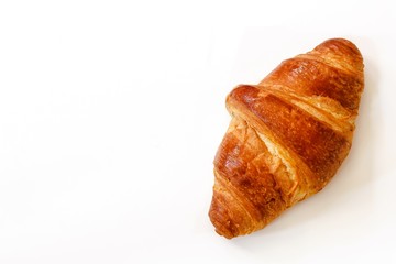 Single freshly baked butter Croissant isolated on white with copy space,top view