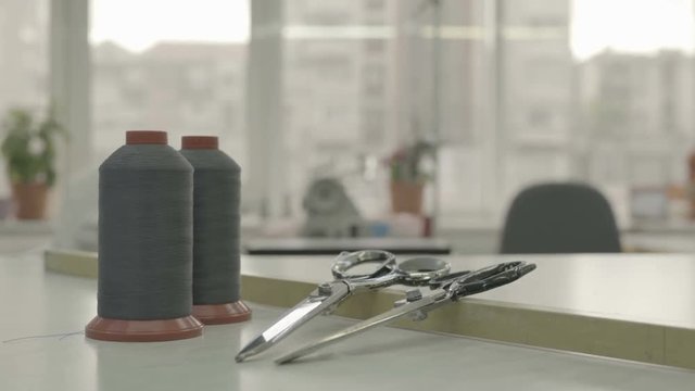 Thread spools and scissors at a tailor shop