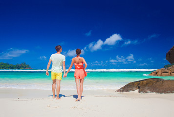 attractive couple enjoying sunny day at Baie Lazare Beach. Mahe, Seychelles