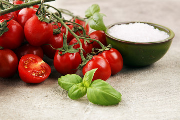 Ripe tasty red tomatoes with salt and basil. Village market organic tomatoes. Fresh tomato