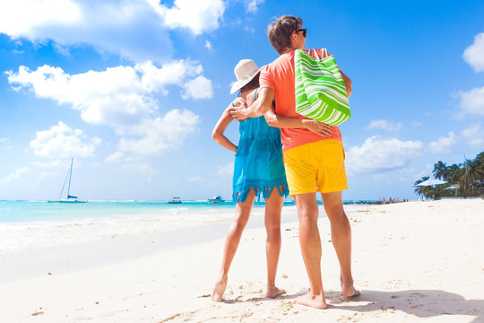 Couple wearing bright clothes on a tropical beach on Barbados