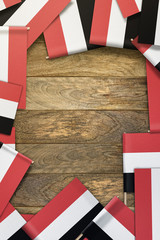 Fototapeta na wymiar Yemen small flags framing a wood texture background with copy space