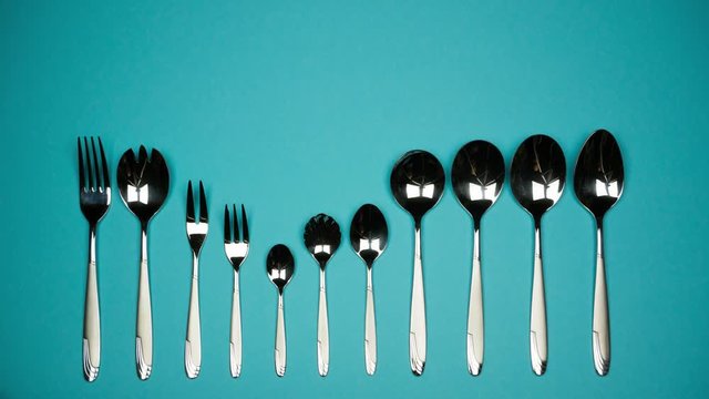 A number of forks and spoons for different dishes.
