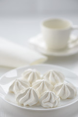Fototapeta na wymiar meringues in a plate on a white background