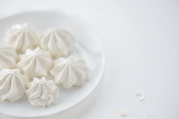 meringues in a plate on a white background
