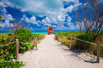 Miami Beach in South Beach with new lifeguard tower and coastline with colorful cloud and blue sky....