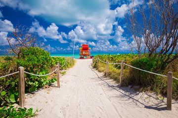 Miami Beach in South Beach with new lifeguard tower and coastline with colorful cloud and blue sky....