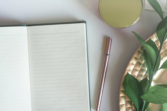 Top view desktop with notebook copy space leaves