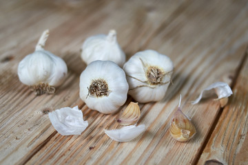 Light wooden background with garlic