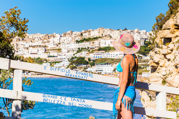 Peschici, apulia, italy, 29 May 2017. Woman in bikini admires the splendid panorama of Peschici, Apulia, Italy