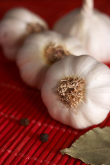On the red style table, seasonings: garlic, black pepper peas and bay leaf