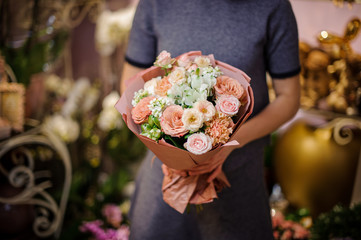 Girl holding a beautiful bouquet of white and peach flowers