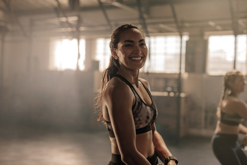 Smiling young women in gym.
