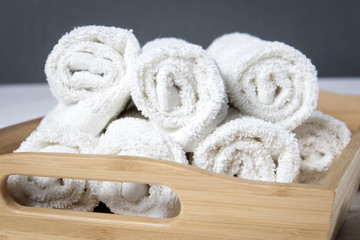 the White spa towels pile in tray isolated on white background